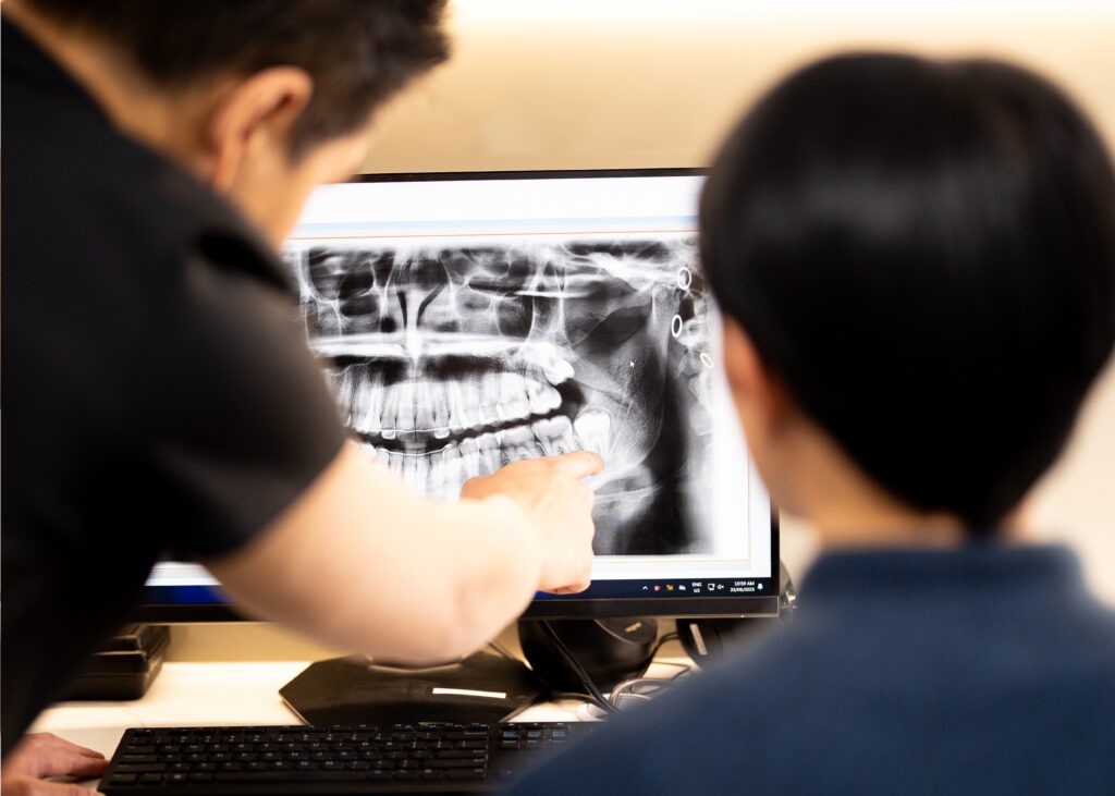 Dentist reviewing a panoramic dental X-ray with a patient