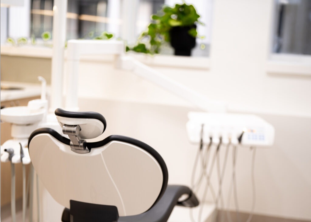 Dental chair and equipment in a bright treatment room