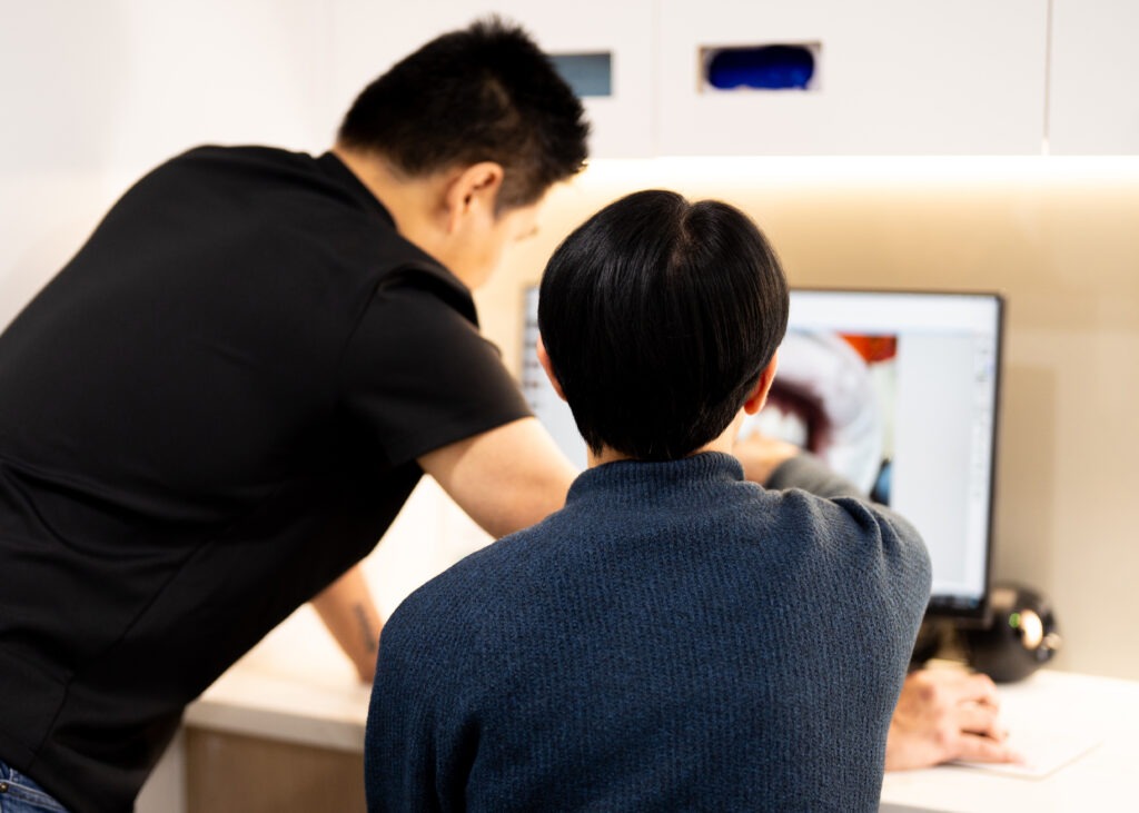 Dentist discussing a dental image with a patient